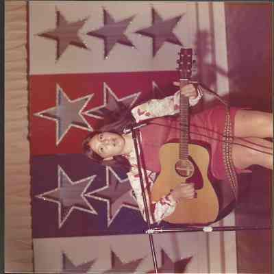 Nancie Boudreau rehearsing her song while accompanying herself on the guitar.