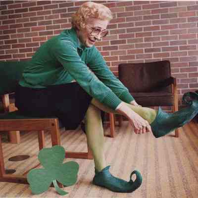 A photo view of a woman getting ready for St. Patrick's Day. 3/16/1987.
