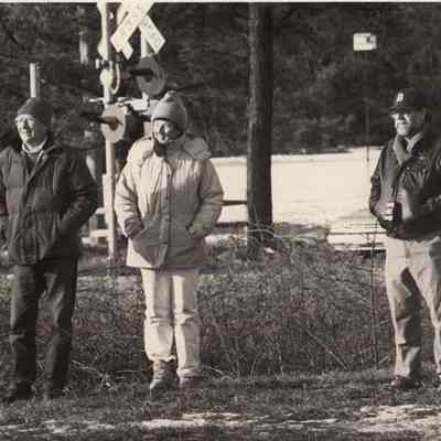 A photo view of three people watching c-5A cargo planes at BNAS. 1/9/1992.