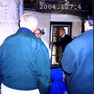 J. Query showing his clay model of the JL Chamberlain statue to some people.