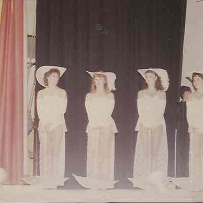 A color photograph of Phyllis Glenn introducing the parade of costumes