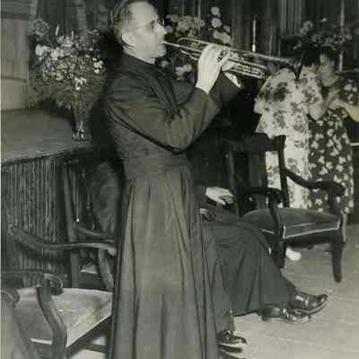 Father Dauphin Playing a Trumpet