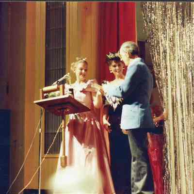 Darby Labbe and Kristine Stevens giving Gene Gagne a gift.