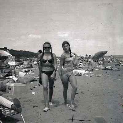 A B/W photograph of two girls on the beach.