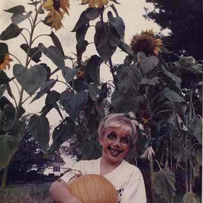 A photo view of a girl with a pumpkin. 10/31/1988.
