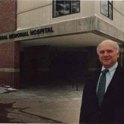 A photo view of a man in front of the hospital. 1/27/1987.
