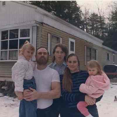 A photo view of a family outside a mobile home. 12/29/1988.