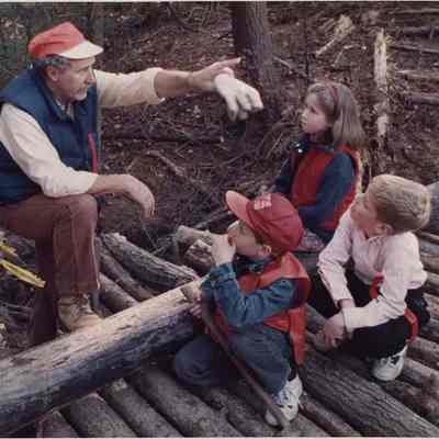 A photo view of a man talking to children. 11/21/1991.