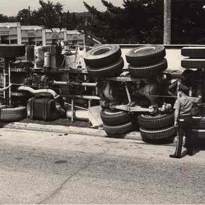 A photo view of an overturned truck.