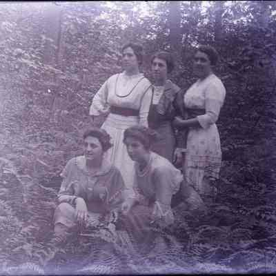 Five women in the woods.
