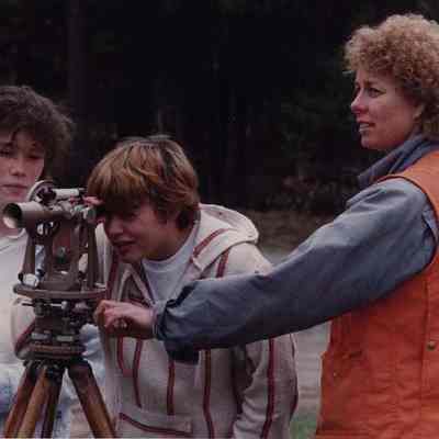 A photo view of 2 youngsters looking through a level. 5/4/1989.