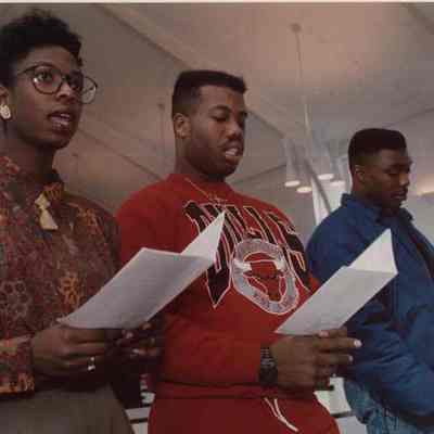A photo view of 4 people singing. 1/20/1992.