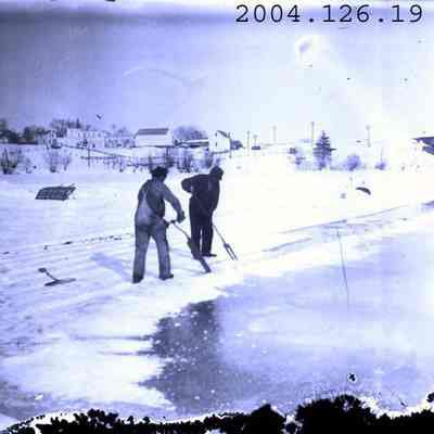 Photo of men cutting ice on the Androscoggin River.
