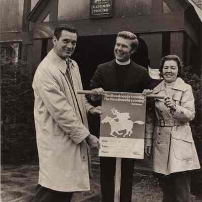 A photo view of three people in front of St. Paul's Codman House.