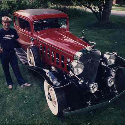 A photo view of a man and an antique car. 7/5/1990.