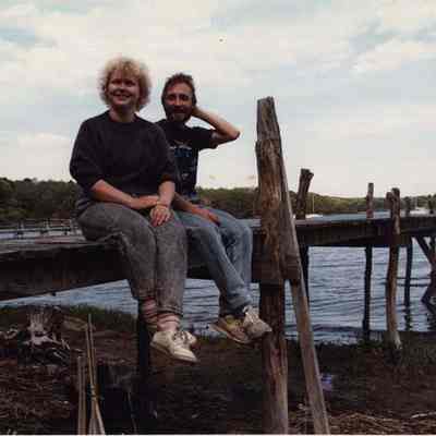 A photo view of a couple sitting on a dock. 6/4/1990.
