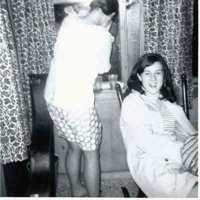 A B/W photograph of two young people partying.