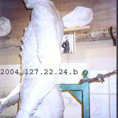 Color photo of the JLC statue's hand holding the hat.