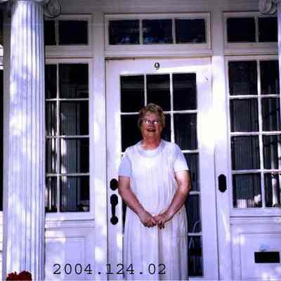 Photograph of Nancy Latilla Standing in front of her door way.