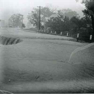 A photo of a washout on Maine Street Topsham. 9/12/1954.