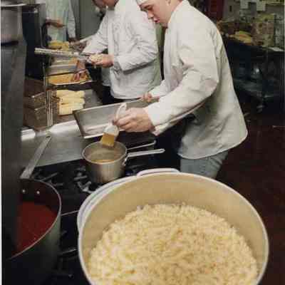 A photo view of a group of cooks preparing dinner. 9/18/1991.