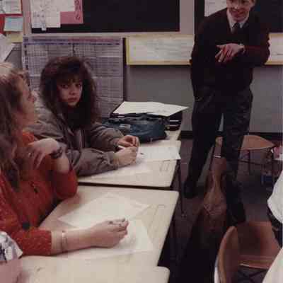A photo view of a teacher and some students. 4/23/1990.