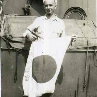 Louis Bernier holding a Japanese flag.