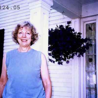 Photo of Lynn Ensign in front of her house.