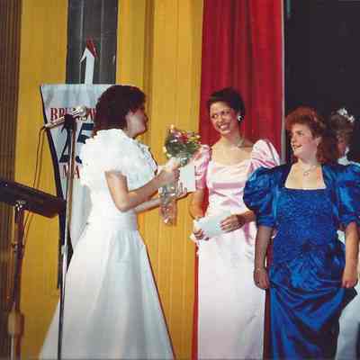 Chressie Gagne presenting flowers to M.C. Laurie Deschene