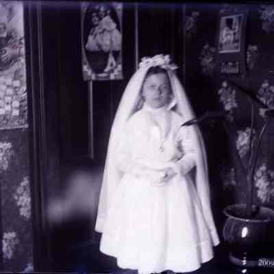 A child standing. All dressed up.