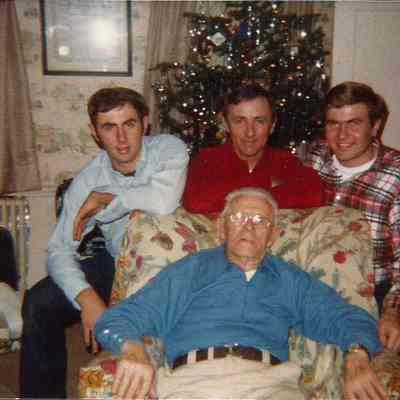 Samuel Holbrook and Three Unidentified Men Sitting in Front of a Christmas Tree