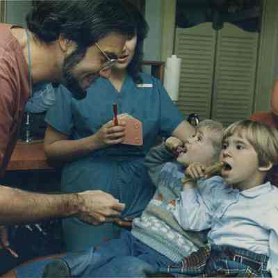 A photo view of 2 children at the dentist. 10/17/1988.