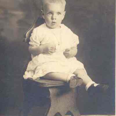 A photo of a baby boy seated.