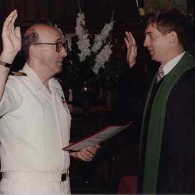 A photo view of someone taking an oath. 9/15/1989.