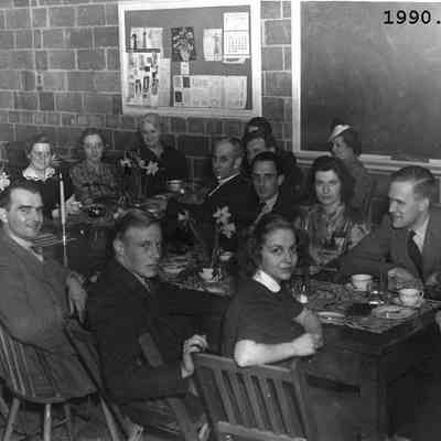 A photo of a group of teachers & students at a tea.
