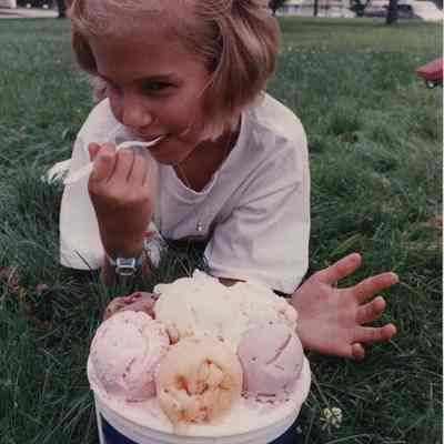 A photo view of a little girl eating ice cream. 7/17/1989.