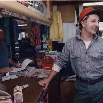 A photo view of a man buying a carton of milk. 11/4/1991.