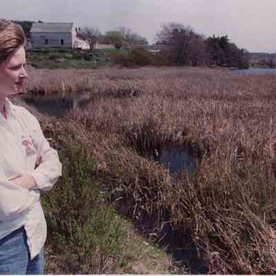 A photo view of a lady looking at a marsh. 5/17/1989.