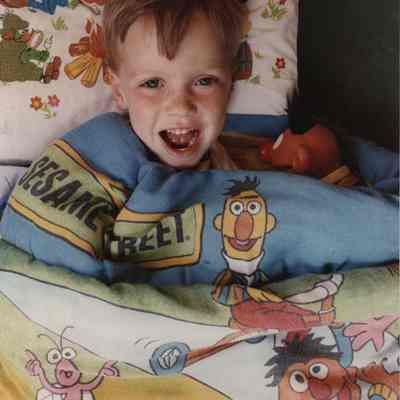 A photo view of a little boy in bed. 7/10/1989