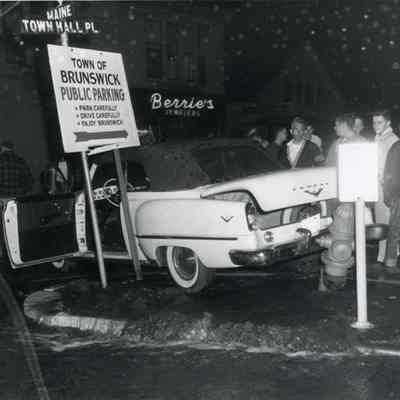 A photo of a car that hit a fire hydrant. 6/24/1955.