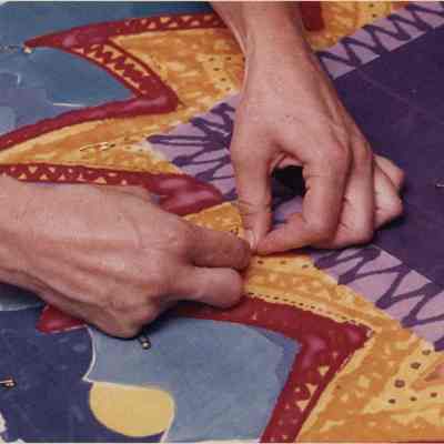 A photo view of pinning a decoration to something. 9/12/1991.
