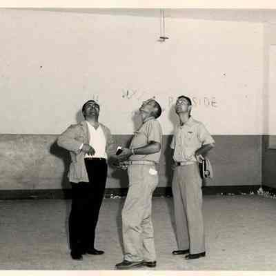Two Navy Men in an Empty Room