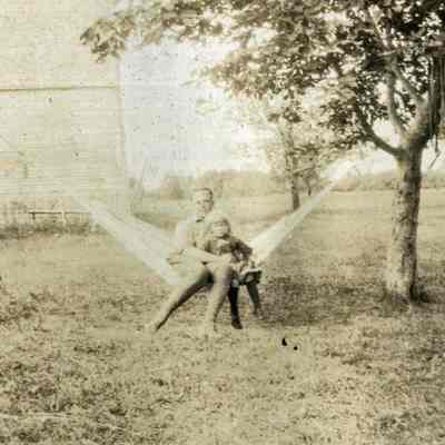 Man and Child Sitting on a Hammock