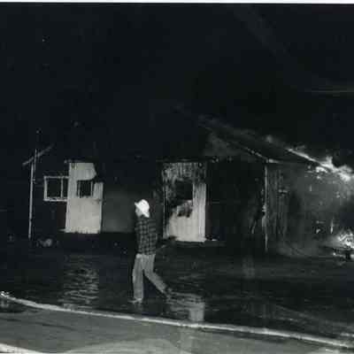 A photo of one of the animal sheds burning.