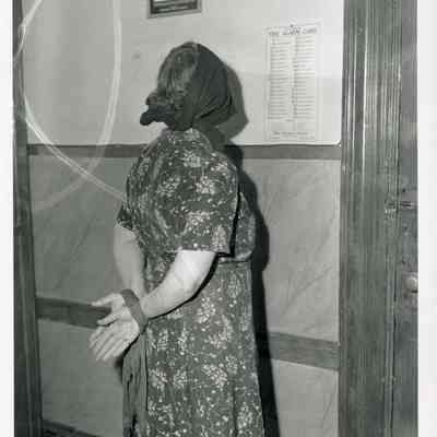 Florence Hessal, Brunswick police matron, with hands tied and face covered