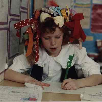 A photo view of a girl with an artistic hairdo. 2/12/1990.