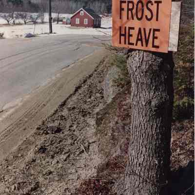 A photo view of a "Frost Heave" sign. 3/7/1990.