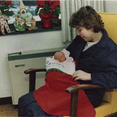 A photo view of Claire Grant and her baby. 12/18/1986.