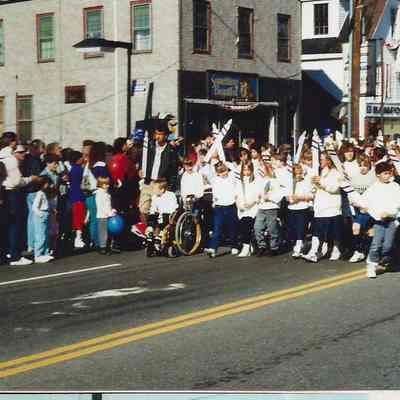 A color photograph of a group of kids in the parade.