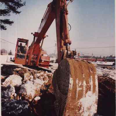 A photo view of a backhoe at work. 1/29/1986.